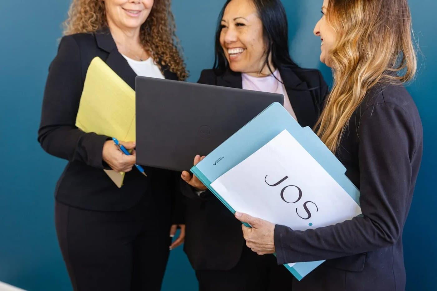 The JOS Family Law team reviewing case materials in JOS-branded folders